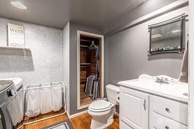 2117 130th Dr NE, Lake Stevens, WA 98258 - bathroom featuring independent washer and dryer, toilet, vanity, and wood finished floors