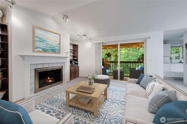 23313 Cedar Way Unit N205, Mountlake Terrace, WA 98043 - living room with track lighting, a fireplace, and vaulted ceiling