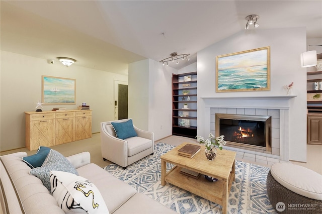 23313 Cedar Way Unit N205, Mountlake Terrace, WA 98043 - living room featuring vaulted ceiling, built in shelves, and a tiled fireplace