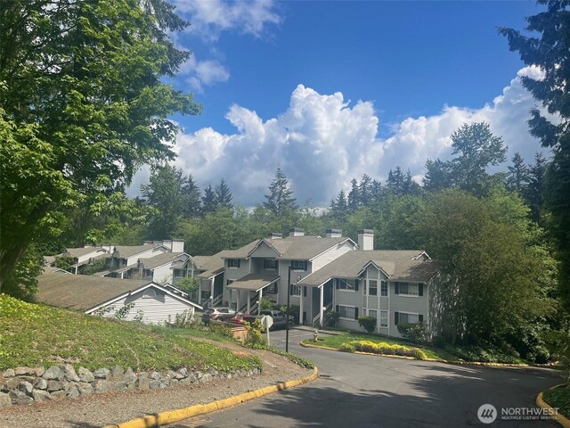 23313 Cedar Way Unit N205, Mountlake Terrace, WA 98043 - view of front of house featuring a chimney and a residential view