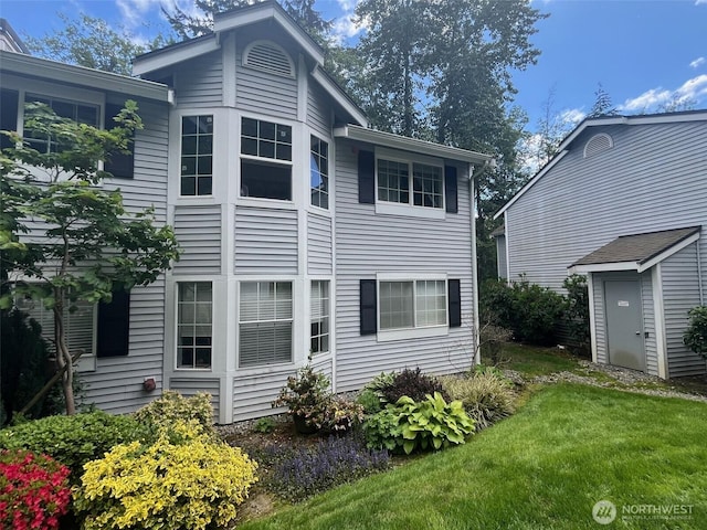 23313 Cedar Way Unit N205, Mountlake Terrace, WA 98043 - back of property with a lawn, a shed, and an outdoor structure