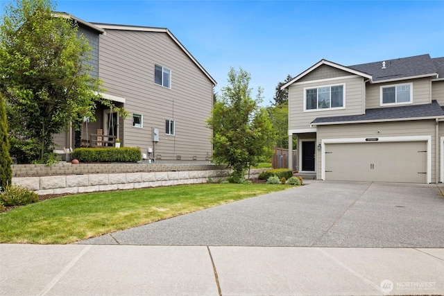28315 64th Ct NW, Stanwood, WA 98292 - view of front of property with an attached garage, driveway, a front yard, and a shingled roof