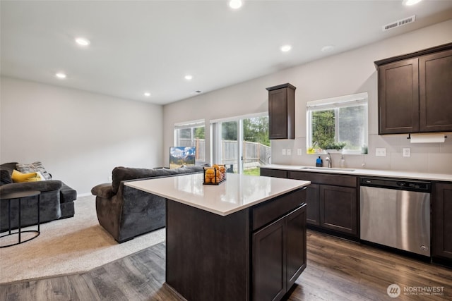 28315 64th Ct NW, Stanwood, WA 98292 - kitchen with stainless steel dishwasher, open floor plan, dark brown cabinets, light countertops, and recessed lighting