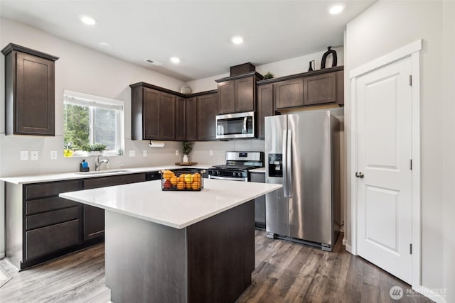 28315 64th Ct NW, Stanwood, WA 98292 - kitchen featuring appliances with stainless steel finishes, dark brown cabinets, light countertops, wood finished floors, and recessed lighting