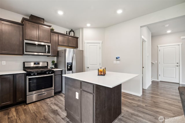 28315 64th Ct NW, Stanwood, WA 98292 - kitchen with stainless steel appliances, dark brown cabinets, light countertops, dark wood-style flooring, and recessed lighting