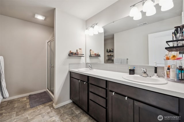 28315 64th Ct NW, Stanwood, WA 98292 - bathroom featuring double vanity, a shower stall, and stone finish floors