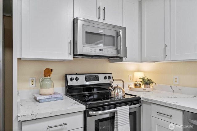 12570 SE 295th St, Auburn, WA 98092 - kitchen featuring stainless steel appliances, white cabinetry, and light stone countertops