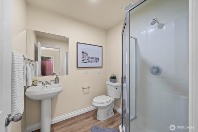 12570 SE 295th St, Auburn, WA 98092 - bathroom featuring a shower stall, wood finished floors, toilet, and baseboards