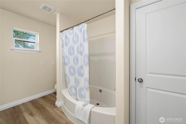 12570 SE 295th St, Auburn, WA 98092 - full bathroom with wood finished floors, baseboards, shower / bath combo with shower curtain, and toilet