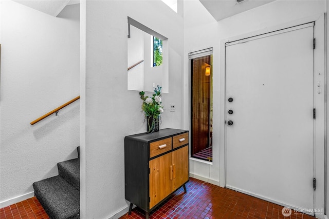 3527 E Spruce St, Seattle, WA 98122 - foyer with brick patterned floors, baseboards, and stairway