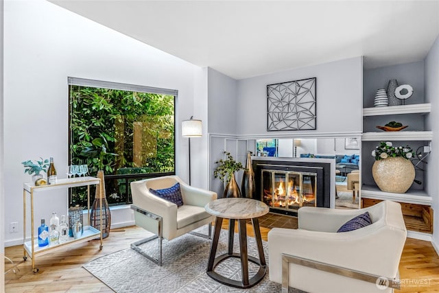 3527 E Spruce St, Seattle, WA 98122 - sitting room featuring wood finished floors and a glass covered fireplace