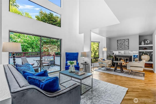 3527 E Spruce St, Seattle, WA 98122 - living room featuring wood finished floors, a fireplace, and a towering ceiling