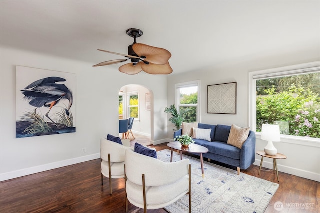 2016 Marine Dr, Bremerton, WA 98312 - living room featuring arched walkways, a ceiling fan, wood finished floors, and baseboards