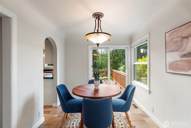 2016 Marine Dr, Bremerton, WA 98312 - dining room with stone tile flooring, arched walkways, and baseboards