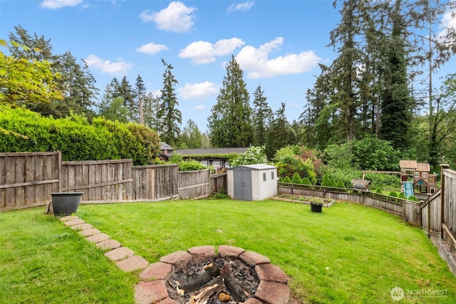 2016 Marine Dr, Bremerton, WA 98312 - view of yard featuring a shed, an outdoor structure, and an outdoor fire pit