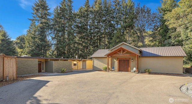 6324 NE 130th Pl, Kirkland, WA 98034 - view of front of house with metal roof, asphalt driveway, and fence