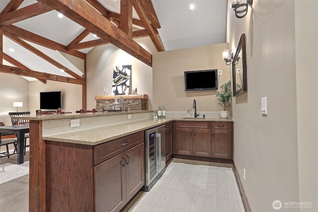 6324 NE 130th Pl, Kirkland, WA 98034 - kitchen with wine cooler, a sink, a peninsula, light stone counters, and open floor plan