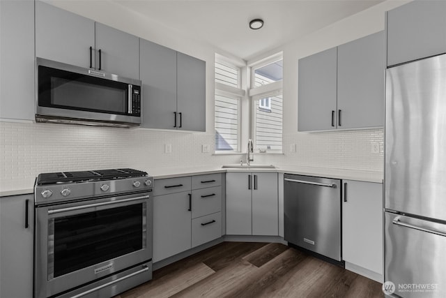 2422C NW 60th St, Seattle, WA 98107 - kitchen with appliances with stainless steel finishes, a sink, gray cabinets, dark wood-style flooring, and light countertops