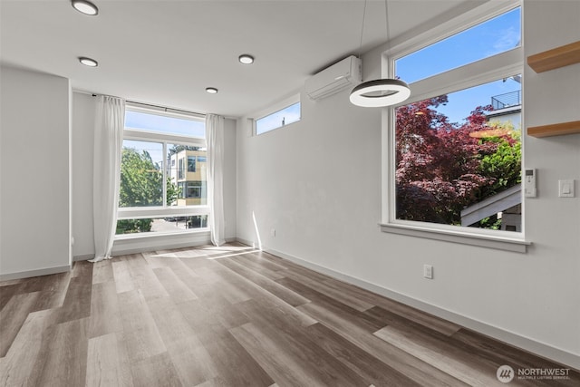 2422C NW 60th St, Seattle, WA 98107 - unfurnished living room featuring a wall mounted AC, wood finished floors, recessed lighting, and baseboards