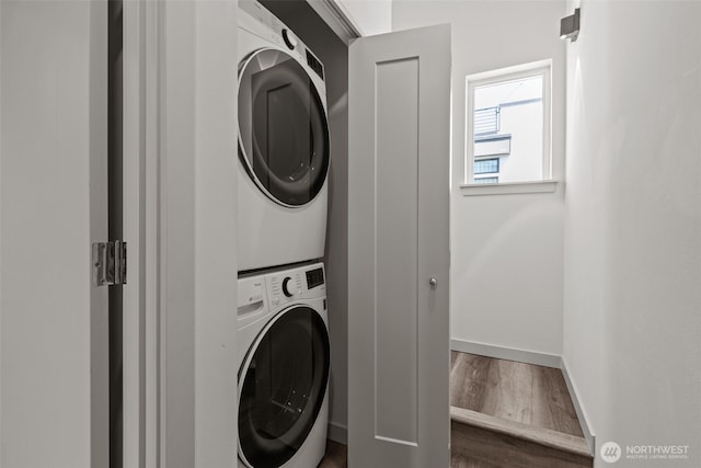 2422C NW 60th St, Seattle, WA 98107 - laundry area featuring stacked washing machine and dryer, dark wood finished floors, and baseboards