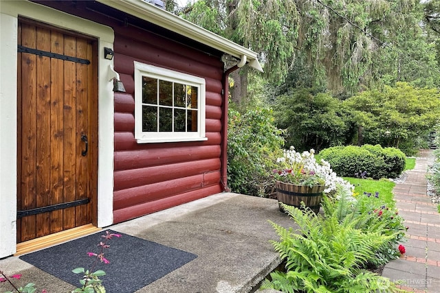 view of exterior entry with log veneer siding