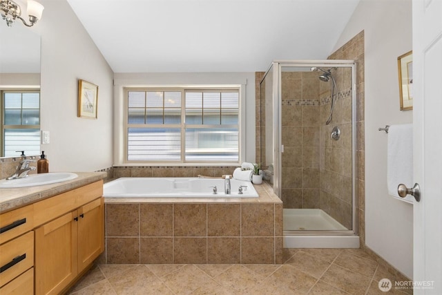 403 21st Ave, Seattle, WA 98122 - bathroom featuring vanity, a bath, vaulted ceiling, a shower stall, and tile patterned flooring