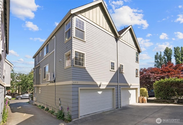 403 21st Ave, Seattle, WA 98122 - view of home's exterior with board and batten siding, a garage, and concrete driveway