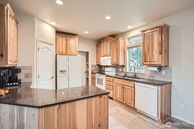 kitchen with white appliances, a sink, a peninsula, tasteful backsplash, and recessed lighting