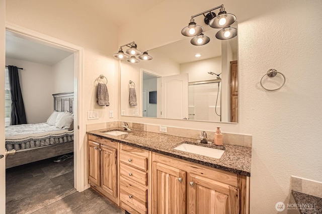 ensuite bathroom featuring double vanity and an enclosed shower