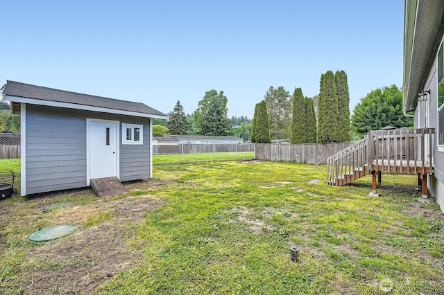 view of yard with a shed, an outdoor structure, and stairs