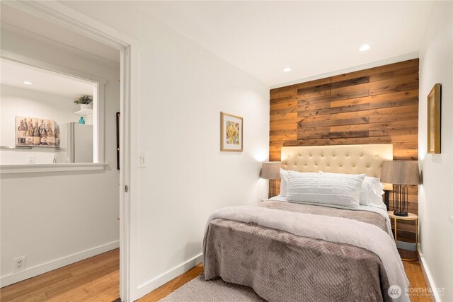 931 N 93rd St, Seattle, WA 98103 - bedroom featuring freestanding refrigerator, wood finished floors, recessed lighting, wooden walls, and baseboards
