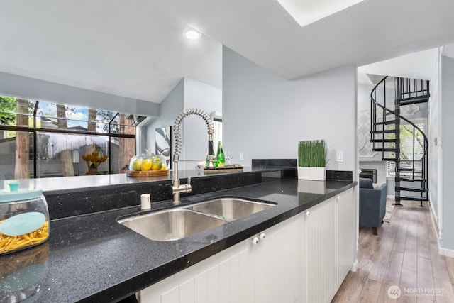 10004 NE 122nd St Unit T-D, Kirkland, WA 98034 - kitchen featuring a sink, white cabinets, dark stone countertops, and plenty of natural light