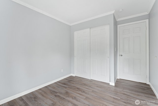 10004 NE 122nd St Unit T-D, Kirkland, WA 98034 - unfurnished bedroom featuring wood finished floors, ornamental molding, a closet, and baseboards