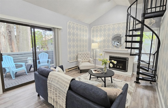 10004 NE 122nd St Unit T-D, Kirkland, WA 98034 - living area featuring a baseboard radiator, stairway, a fireplace, lofted ceiling, and wood finished floors