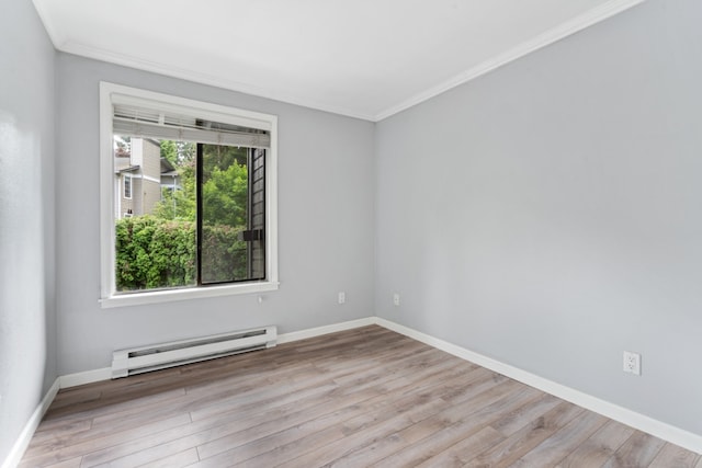 10004 NE 122nd St Unit T-D, Kirkland, WA 98034 - spare room featuring a baseboard heating unit, ornamental molding, wood finished floors, and baseboards