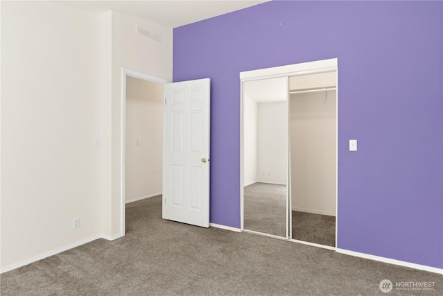 unfurnished bedroom featuring carpet flooring, a closet, and baseboards