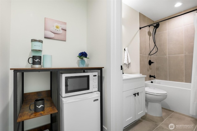 full bathroom featuring toilet, tile patterned floors, tub / shower combination, and vanity