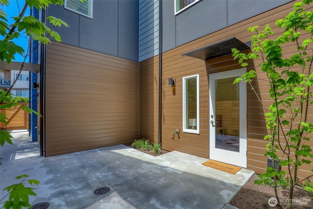 view of exterior entry featuring a patio area
