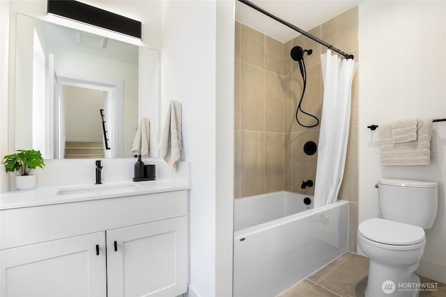 bathroom featuring toilet, vanity, shower / bath combo with shower curtain, and tile patterned floors
