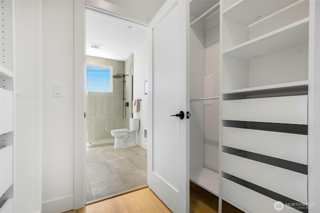 walk in closet featuring wood finished floors
