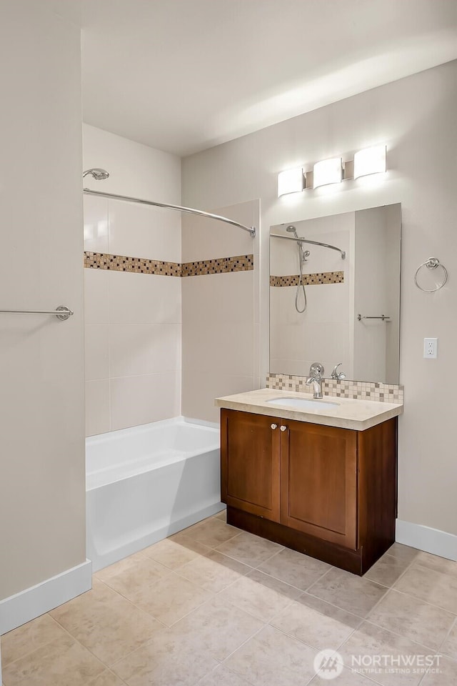 bathroom with shower / bathtub combination, tile patterned flooring, baseboards, and vanity