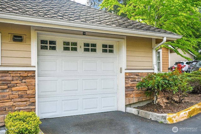 garage with asphalt driveway