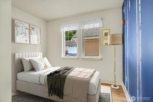 bedroom with wood finished floors and baseboards