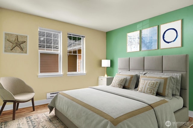 bedroom with wood finished floors and baseboards
