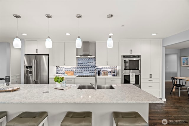 4354 Dyes Inlet Rd NW, Bremerton, WA 98312 - kitchen featuring stainless steel appliances, wall chimney exhaust hood, a sink, a breakfast bar area, and recessed lighting