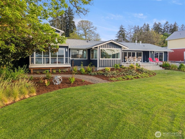 4354 Dyes Inlet Rd NW, Bremerton, WA 98312 - back of house featuring a sunroom, board and batten siding, a yard, and roof with shingles