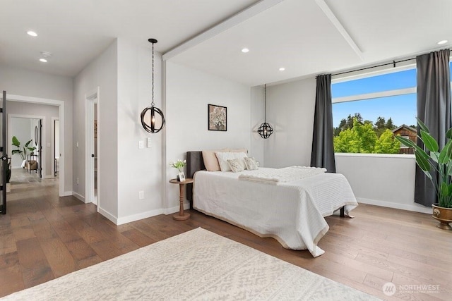 bedroom with baseboards, dark wood-style flooring, and recessed lighting