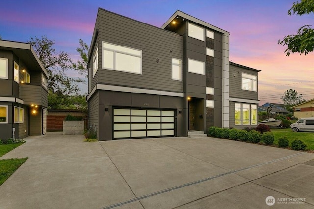 contemporary home with driveway and a garage