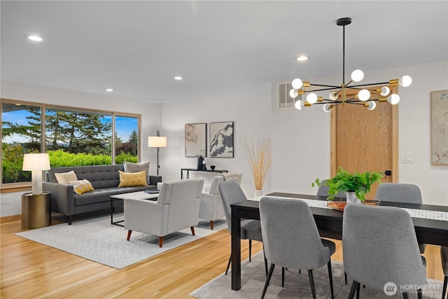 dining room featuring wood finished floors, a chandelier, and recessed lighting