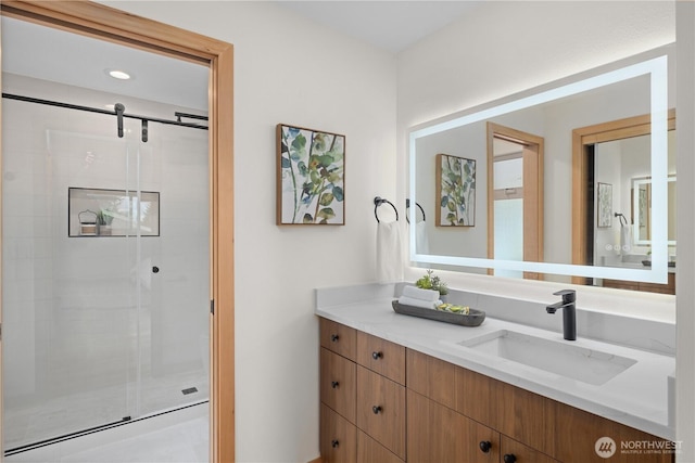 full bath featuring a shower stall, vanity, and recessed lighting